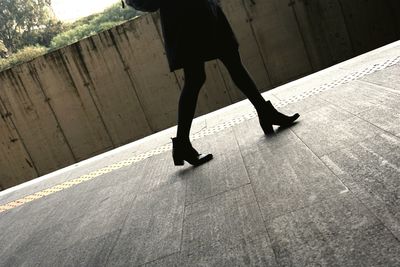 Low section of woman standing on tiled floor