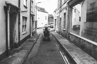 Motorised wheelchair navigating a narrow lane