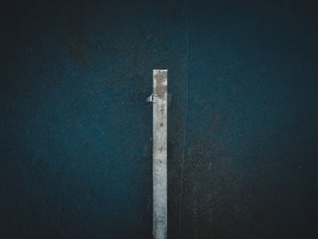 Close-up of metal pole against wall