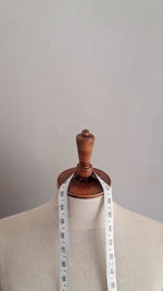 Close-up of cross on table against white background