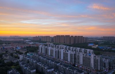 High angle view of buildings against sky during sunset