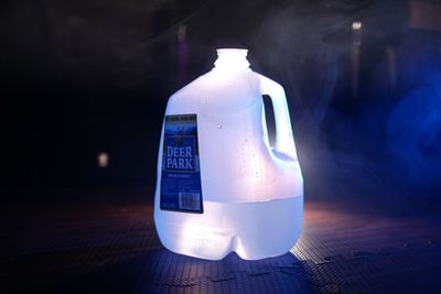 Close-up of illuminated light bulb on table