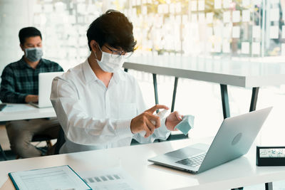 Man using hand sanitizer at office