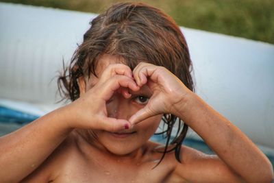 Close-up portrait of girl with hands