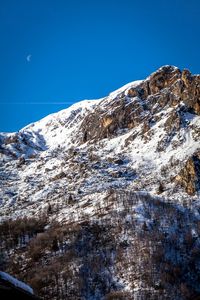 Scenic view of mountains against clear blue sky