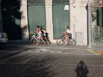 Bicycles riding bicycle on street in city