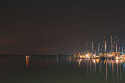 Sailboats in sea at night