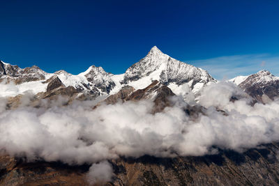 Aerial view of snowcapped mountain against sky