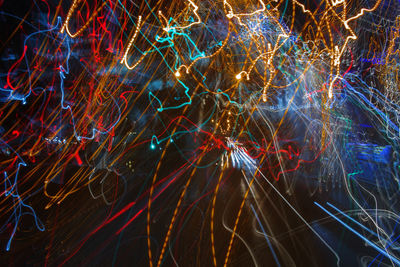 Full frame shot of illuminated light trails at night
