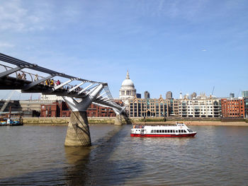 Boats in river with buildings in background