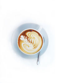 Directly above shot of cappuccino served on white background