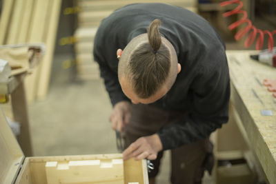 High angle view of man working in workshop