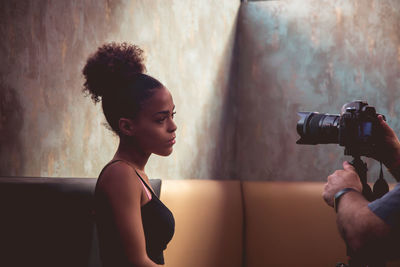 Side view of woman photographing