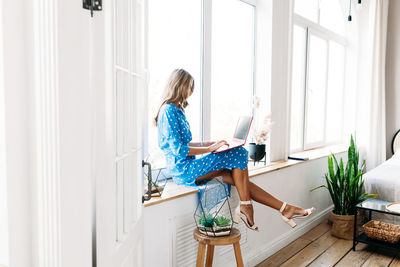 Woman sitting on chair at home