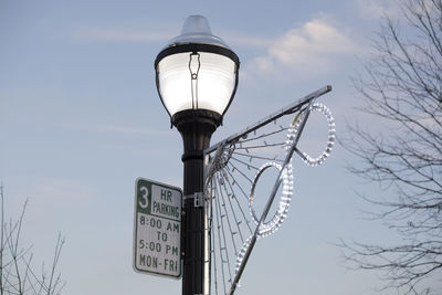 Low angle view of street light against sky