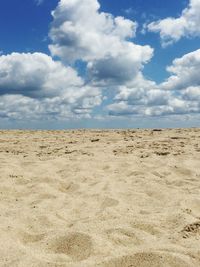 Low angle view of sand on beach against sky