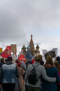 Rear view of people against sky