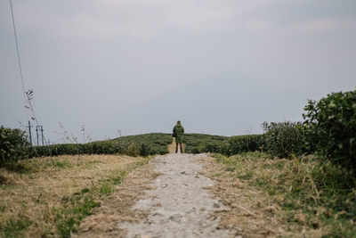 Rear view of man standing on land