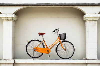 Bicycle leaning against wall