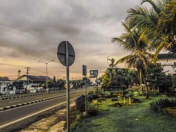 Road by building against sky