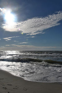 View of calm beach against blue sky