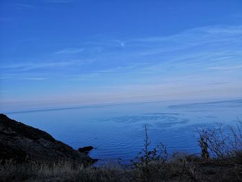 Scenic view of sea against blue sky