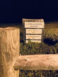 Information sign on field against sky