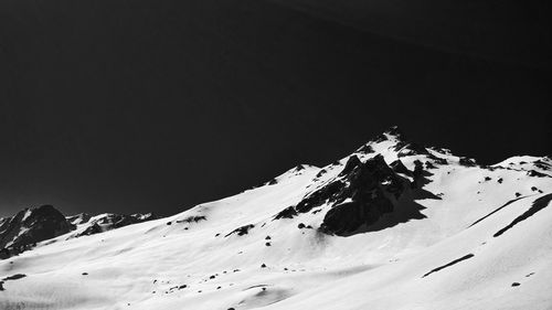 Scenic view of snowcapped mountains against clear sky