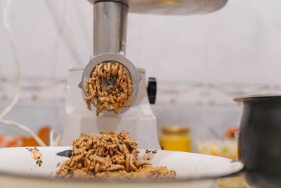 Meat grinder at home kitchen. lifestyle photography. food preparing