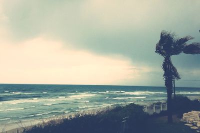 Scenic view of sea against cloudy sky