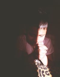 Close-up of boy with hands clasped