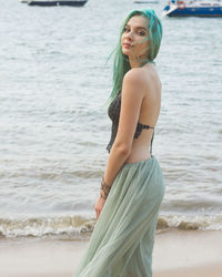 Young woman standing at beach