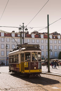 Train on railroad track in city against clear sky