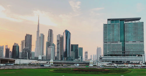 View of buildings in city against cloudy sky