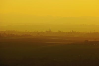 Silhouette of buildings in city during sunset