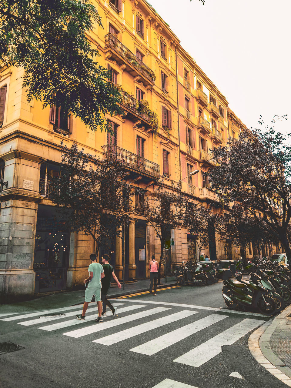 PEOPLE WALKING ON STREET AGAINST BUILDINGS