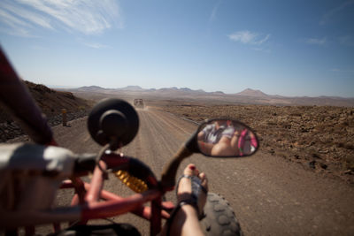 Cropped image of woman on beach buggy against sky