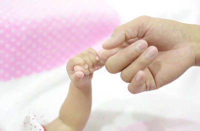 Close-up of hands holding baby hand