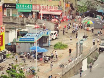 High angle view of people walking on road in city