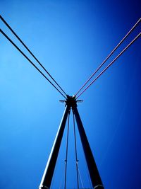 Low angle view of cables against clear blue sky