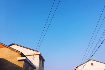 Low angle view of house against clear blue sky