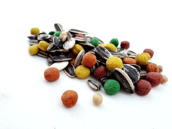 High angle view of multi colored candies against white background