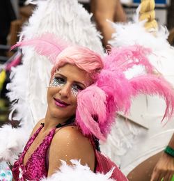 Portrait of woman with pink feathers