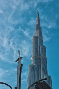 Low angle view of buildings against cloudy sky