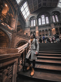 People walking on staircase in building