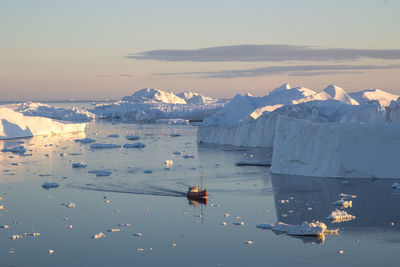 Sailboats in sea against sky during winter