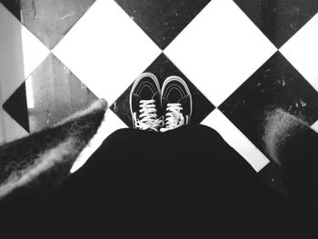 Close-up of woman standing on tiled floor