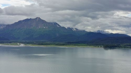 Scenic view of lake and mountains against sky