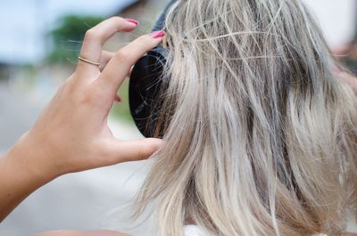 Close-up of woman listening to music through headphones