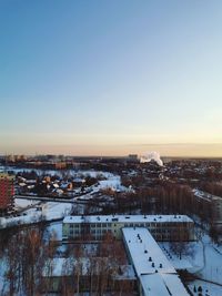 High angle view of buildings against sky during winter morning